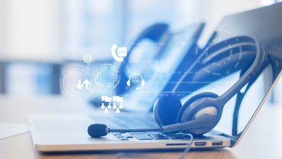 Optimale Prozesse | Service & Sales Foto Laptop, Kopfhörer und Telefon für nahtlose Kommunikation